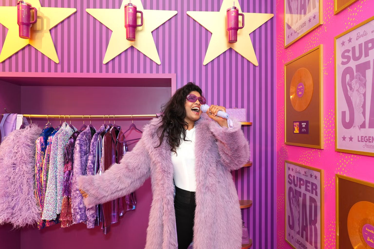 Fan in a lilac faux-fur coat singing into a microphone at Legends Records