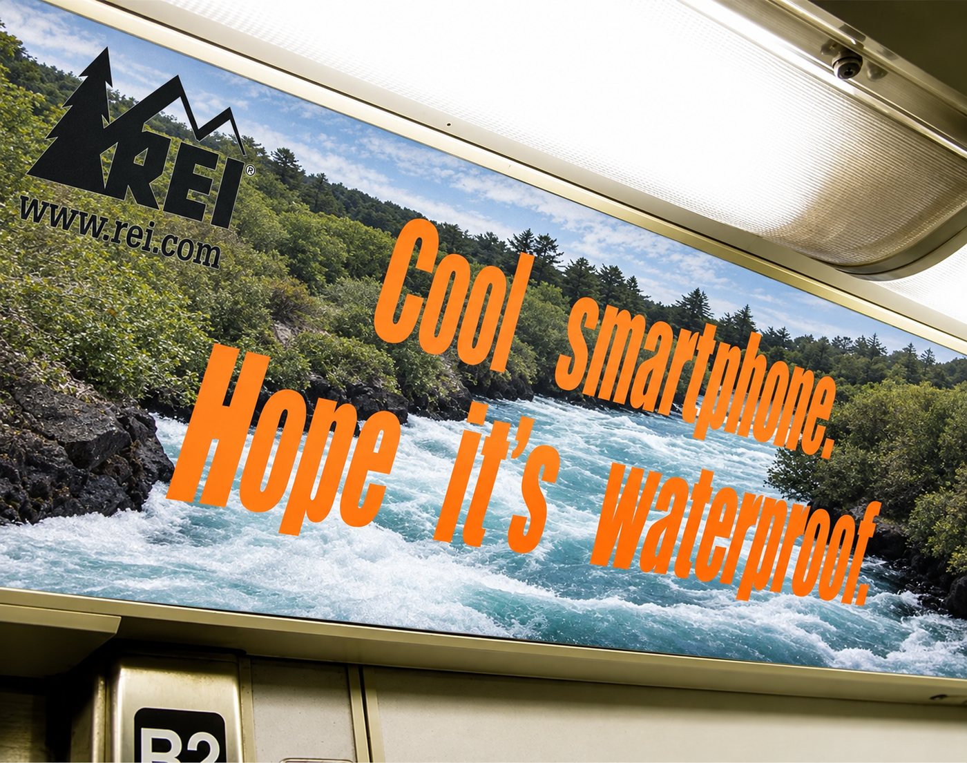 REI car card over whitewater: Cool smartphone. Hope it’s waterproof.