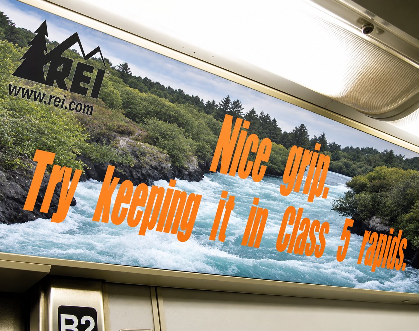 REI car card over whitewater: Nice grip. Try keeping it in Class 5 rapids.