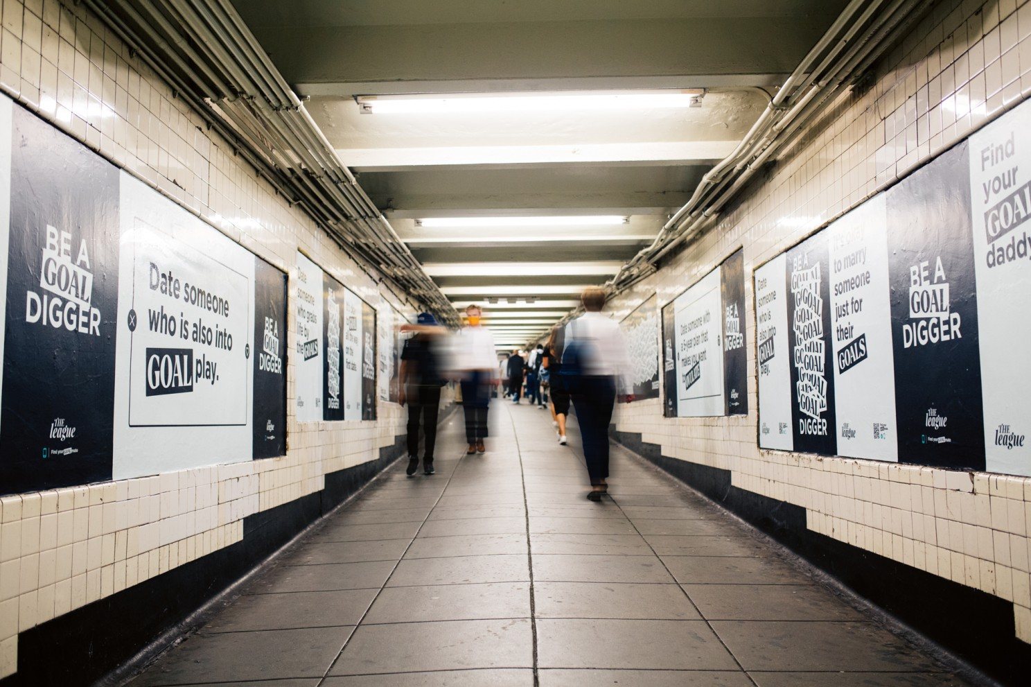 NYC subway corridor lined with Be a Goal Digger posters